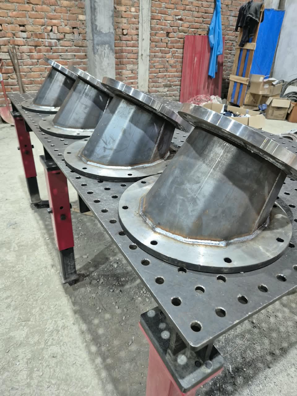 Conical flanged sub-assemblies on welding fixture table