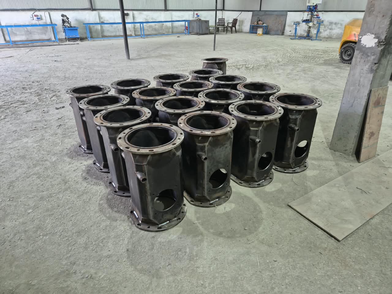 Full batch of completed octagonal welded assemblies on workshop floor